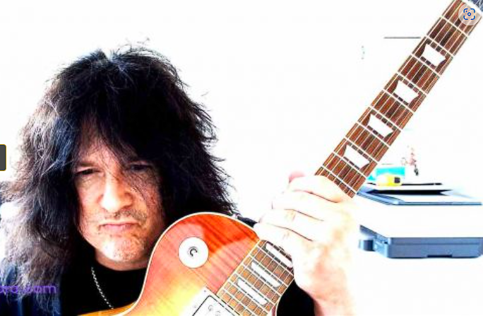 Benny Doro holding his Les Paul guitar