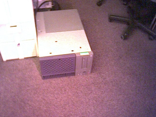 Equipment and travel cases resting on the office carpet.