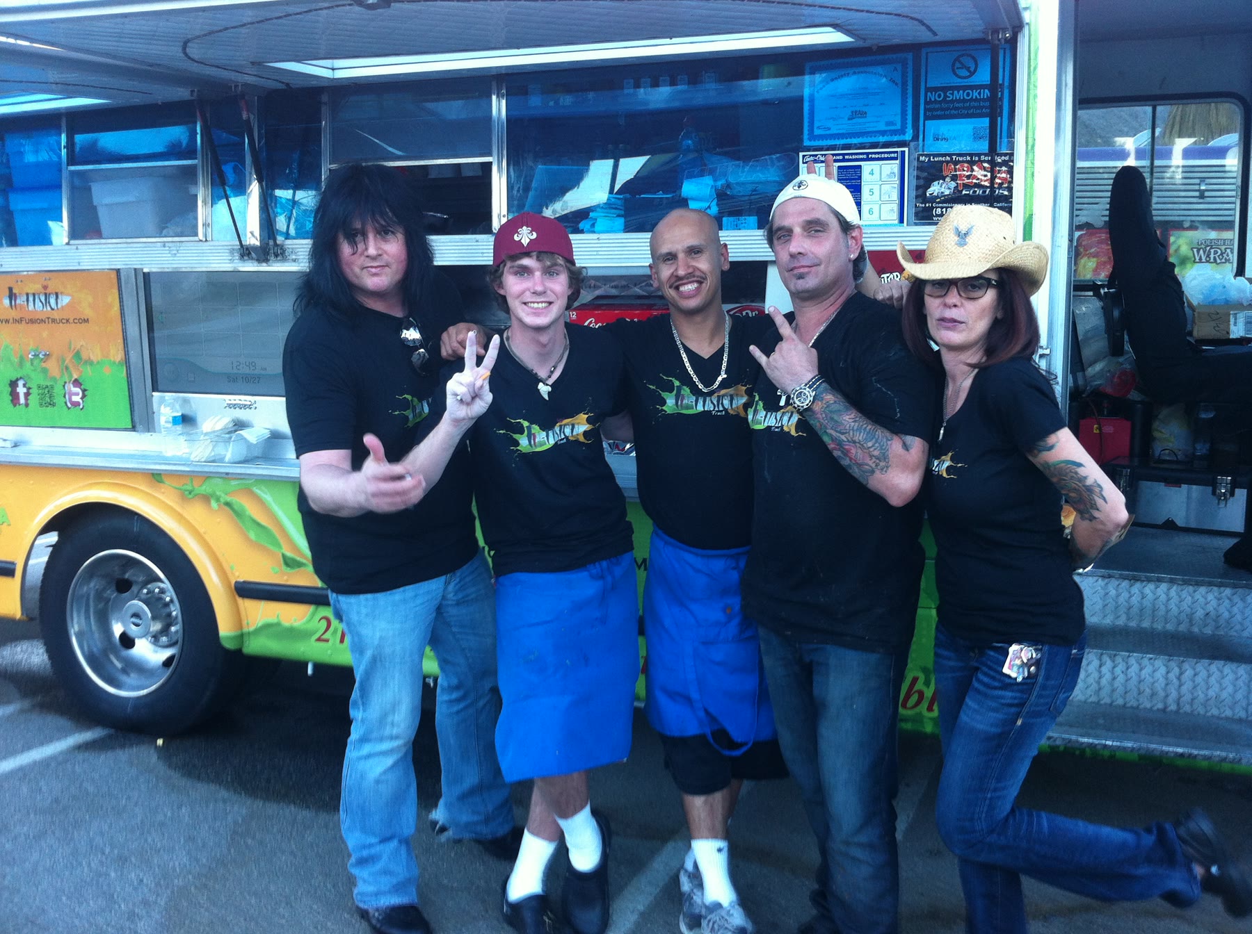 InFusion team members posing together beside the truck; identifications pending.