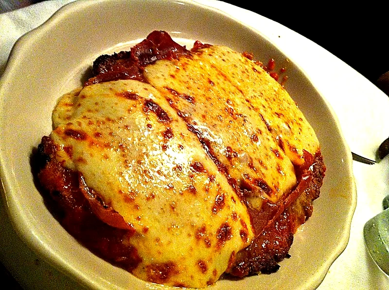 Chicken Parmigiana covered in tomato sauce and melted cheese