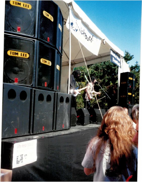 Festival stage viewed from beside a speaker stack
