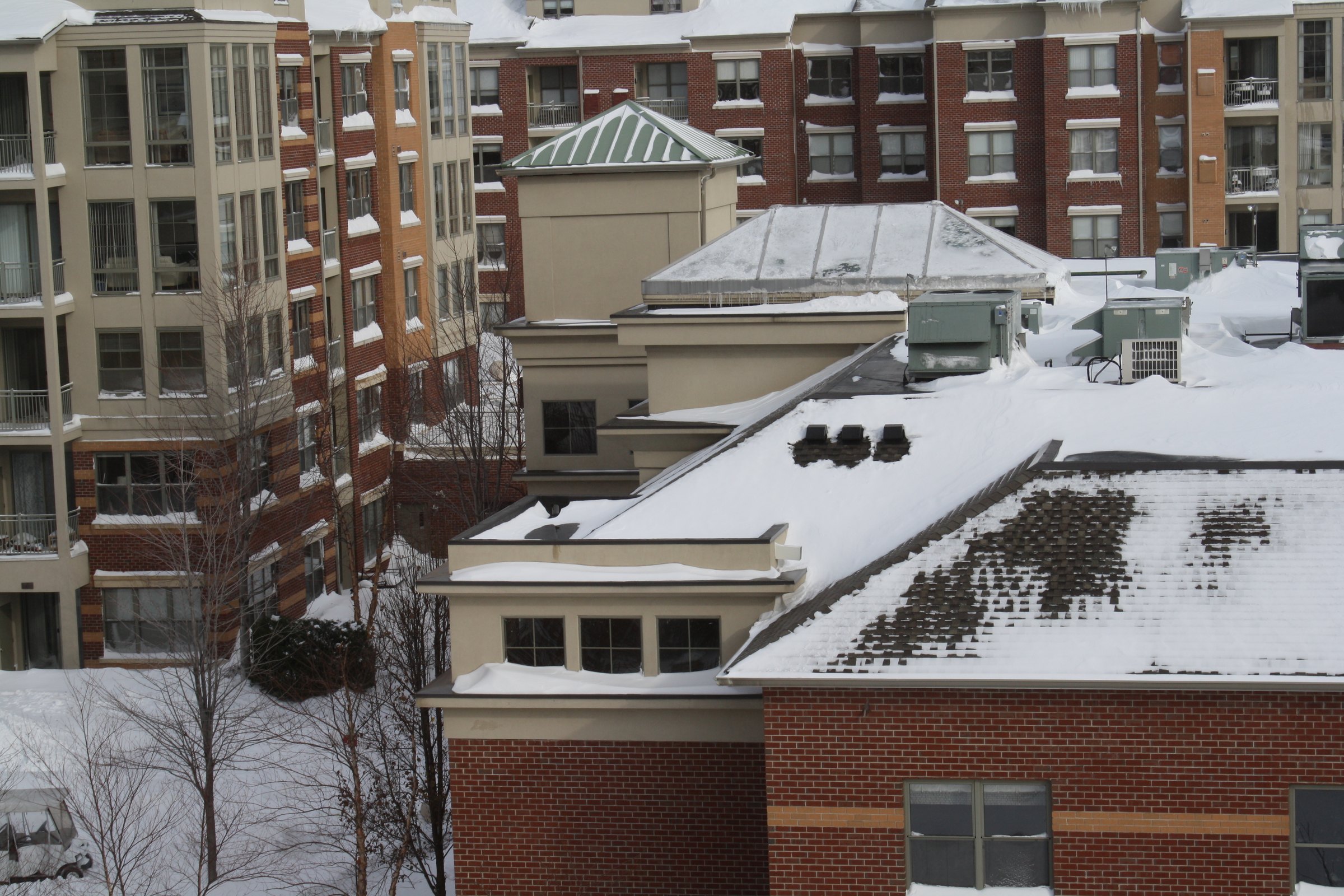 Snow-covered apartment rooftops.
