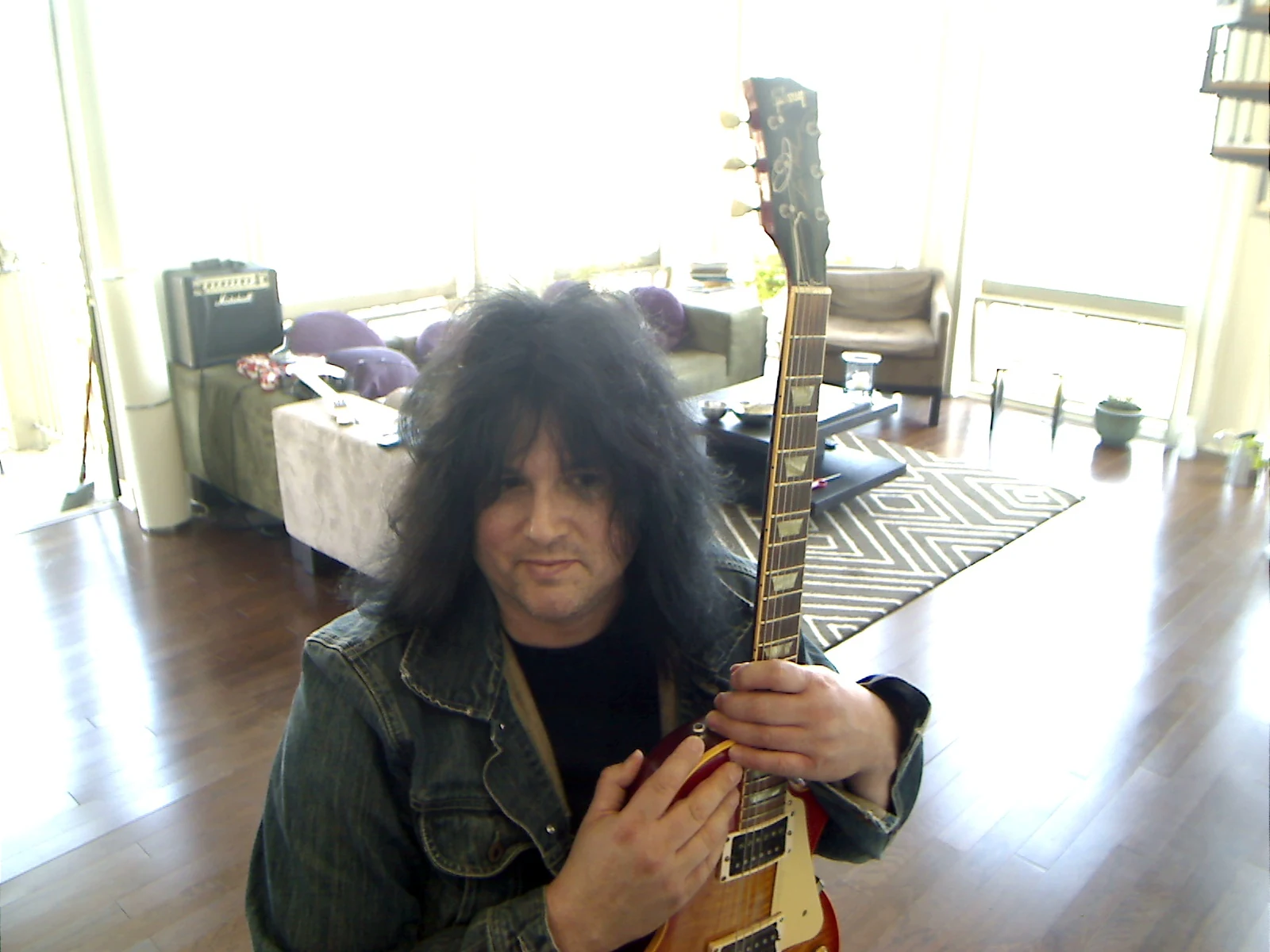 Benny Doro holding his Les Paul upright.