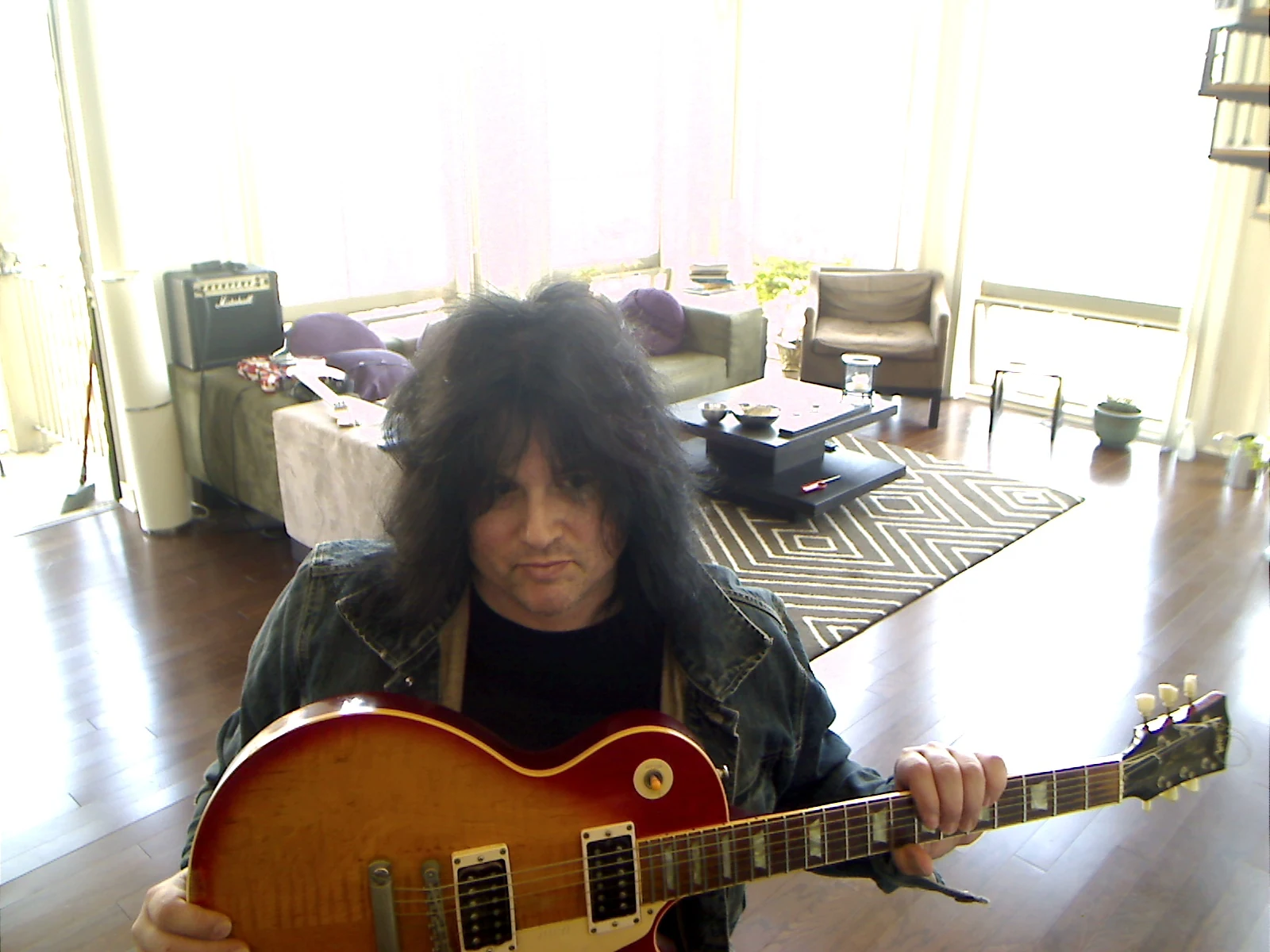 Benny Doro holding his Les Paul across his lap.