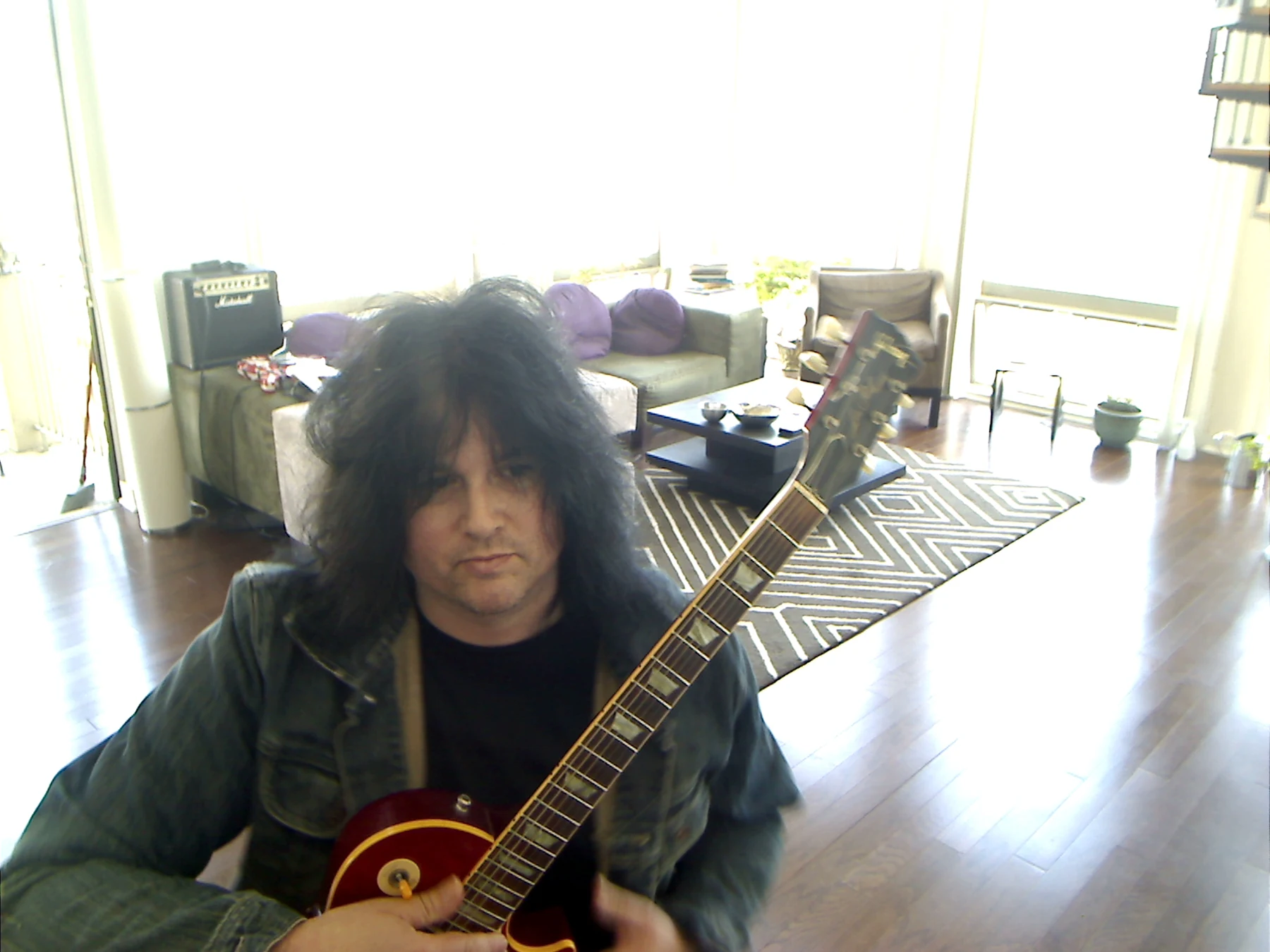 Benny with the guitar crossing the frame.