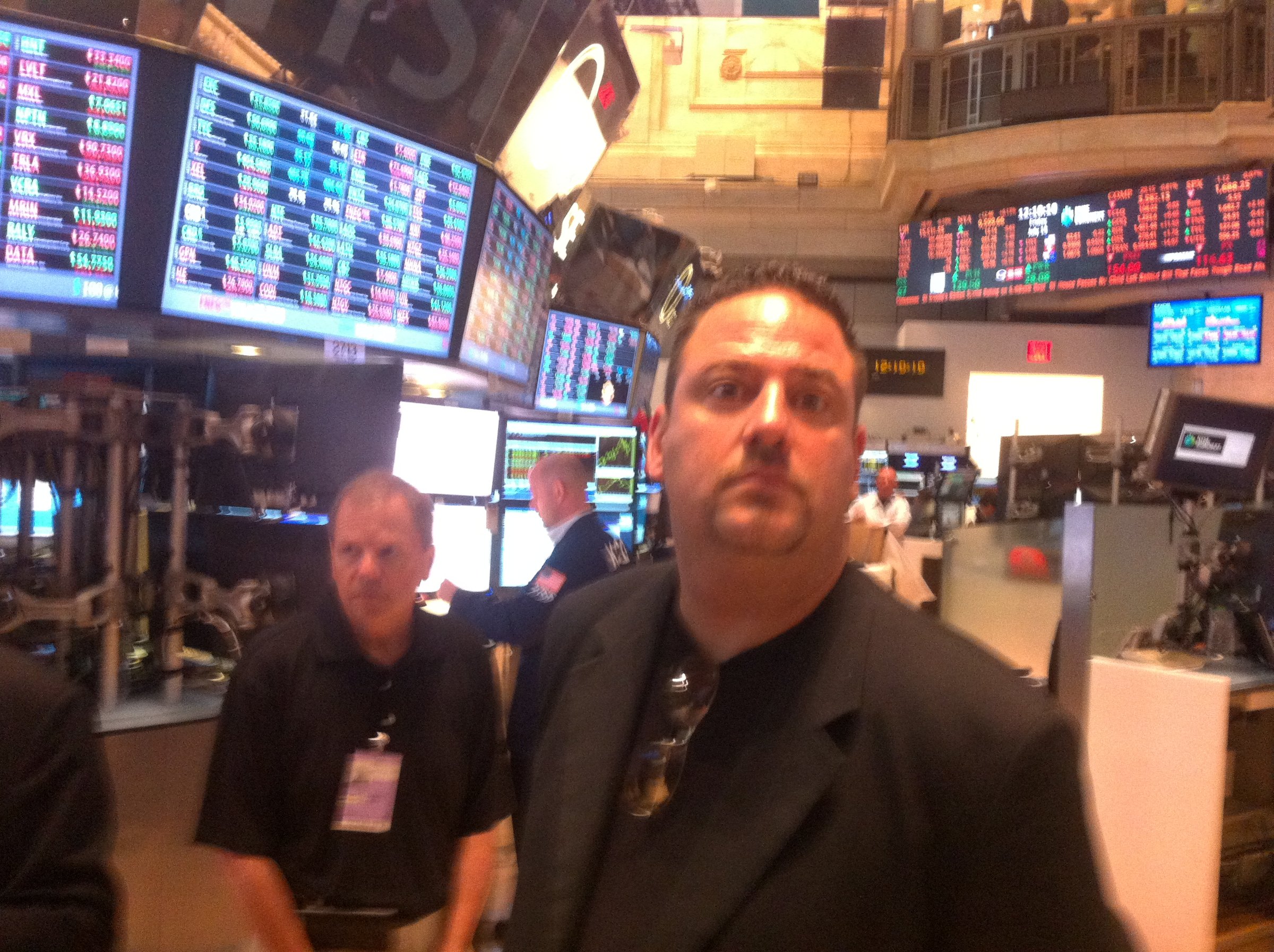Two visitors on the New York Stock Exchange trading floor.