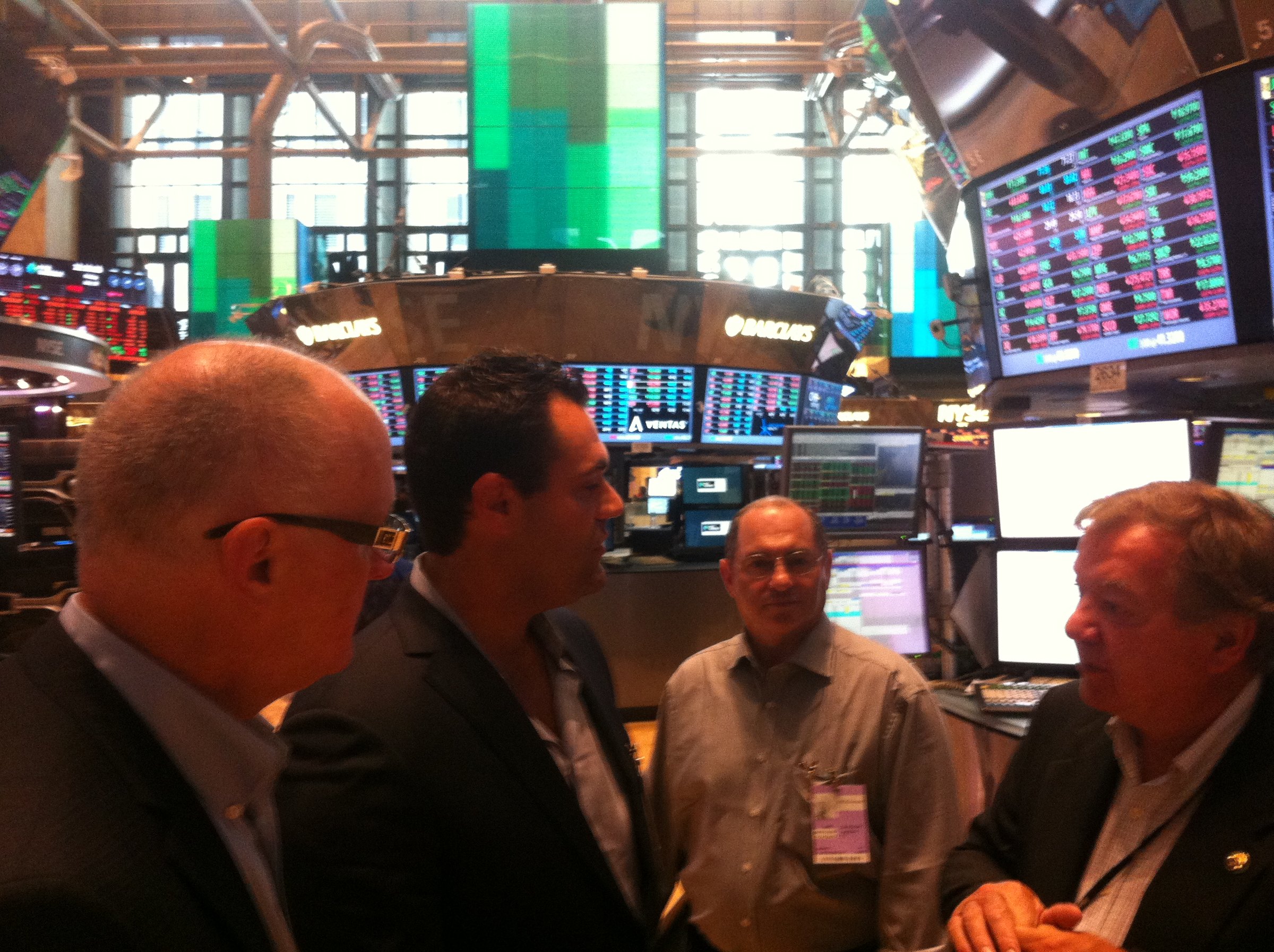 Visitors gathered beneath electronic market displays.