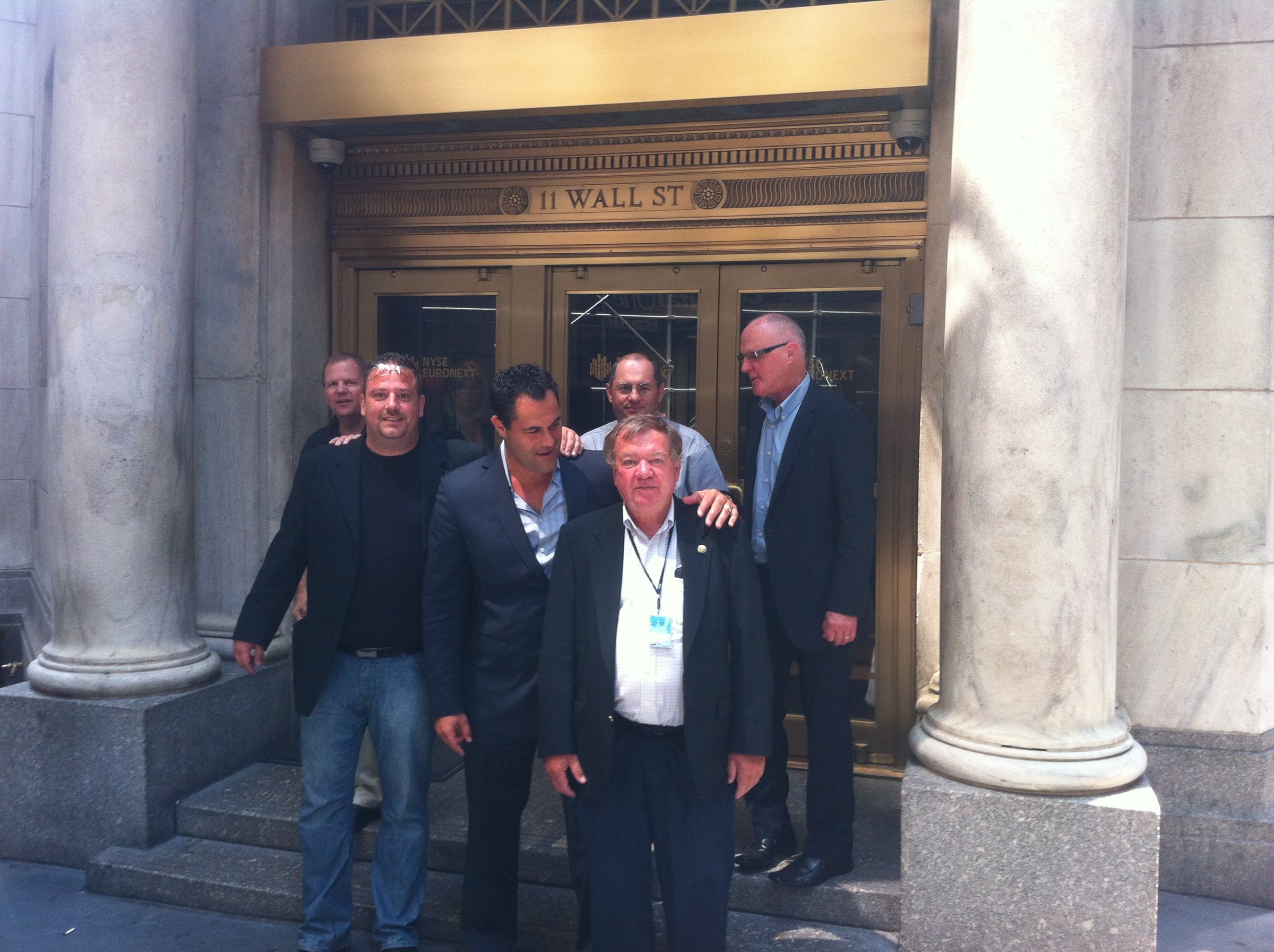 Five men leaving the New York Stock Exchange entrance.
