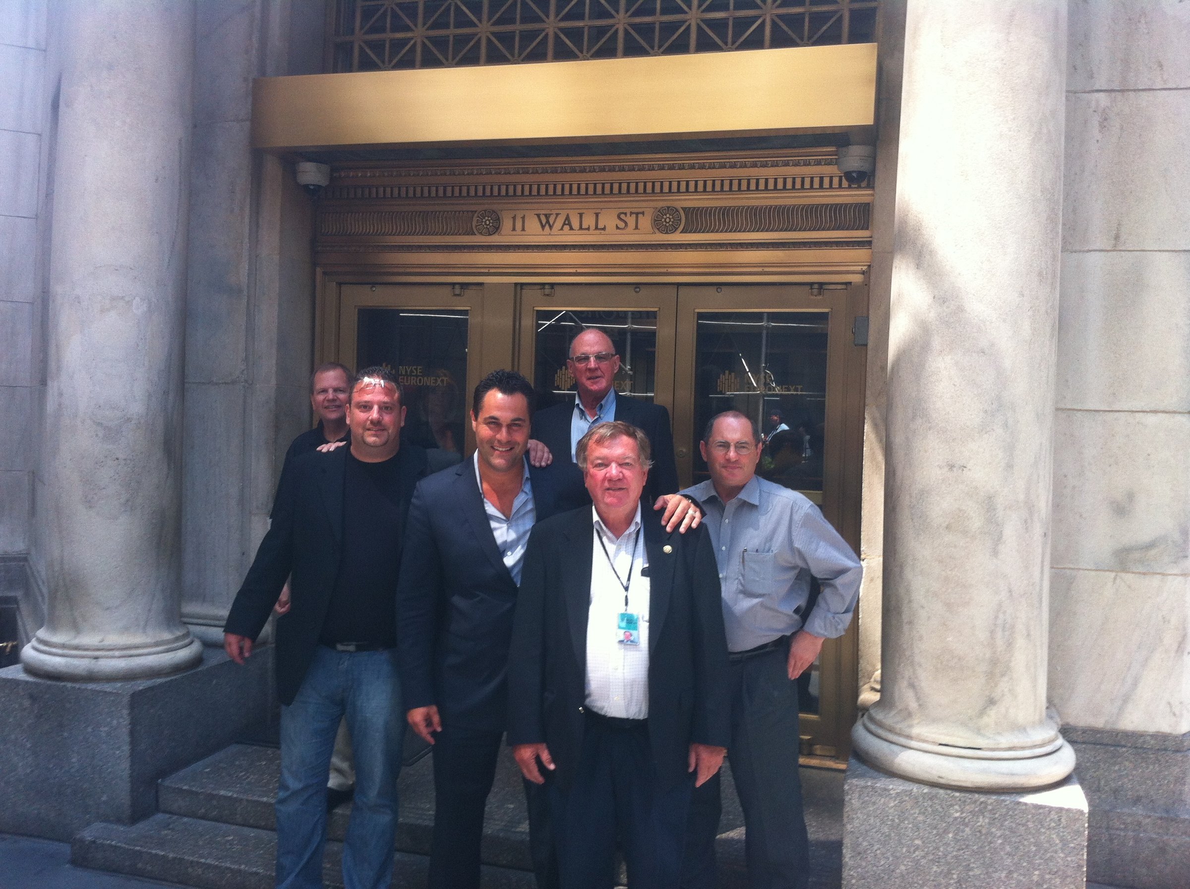 A group outside the New York Stock Exchange entrance at 11 Wall Street.