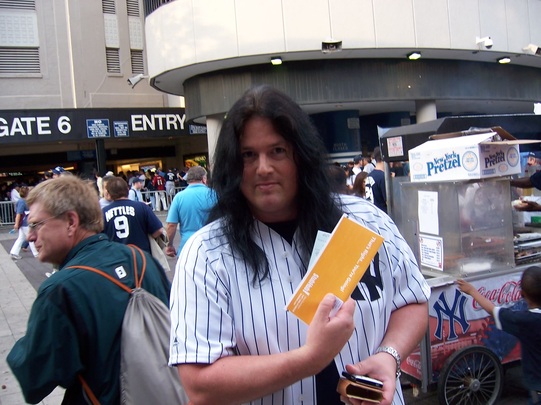 Benny holding the tickets outside Yankee Stadium.