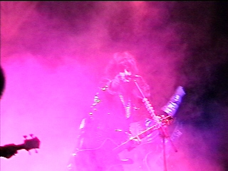 Benny Doro onstage in saturated pink light, photograph 17 of 22