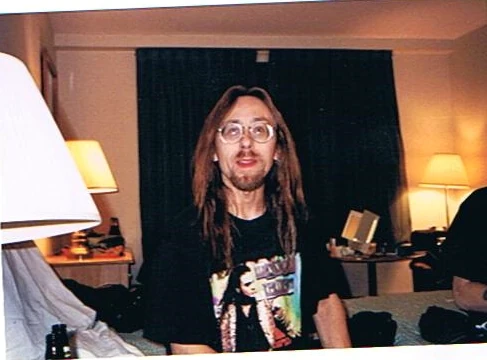 A member of the Black Diamond road family sitting in a hotel room.
