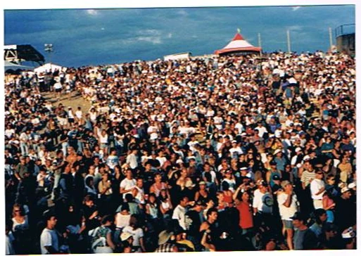 A large outdoor crowd photographed from the stage area.