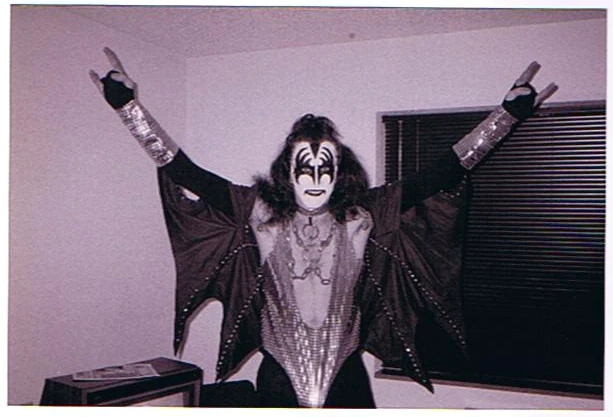 A Black Diamond member in full Demon costume with arms raised.