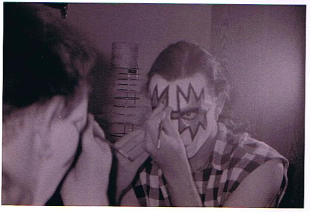 A Black Diamond member applying KISS makeup.