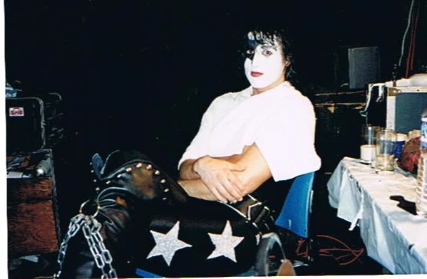 A Black Diamond performer in makeup resting backstage.