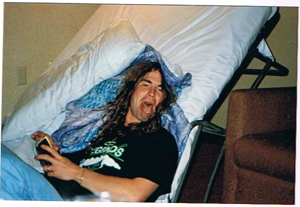 A Black Diamond crew member resting in a hotel bed.