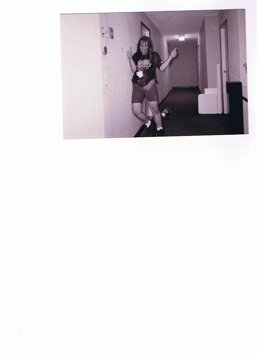 Complete scanned sheet showing a road-crew member posing in a hotel corridor.