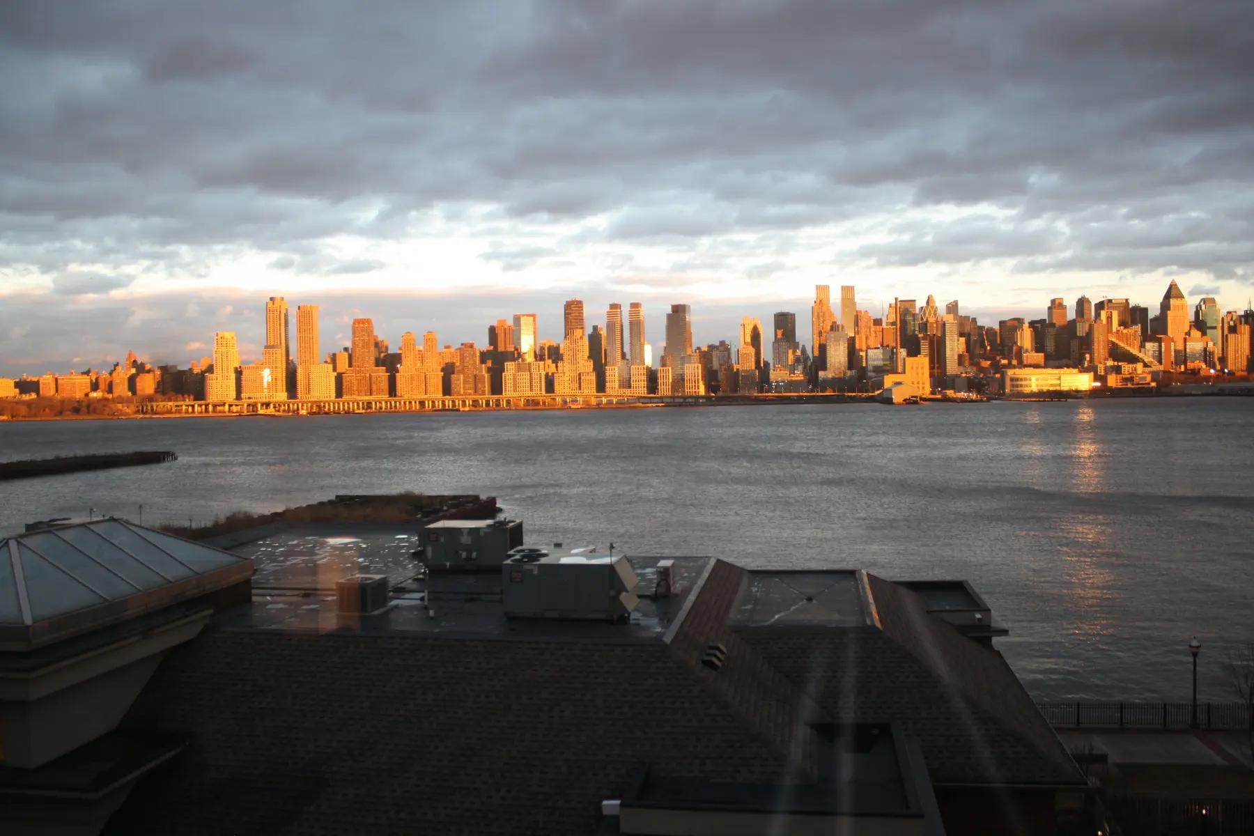 The full Manhattan skyline in winter light across the Hudson.