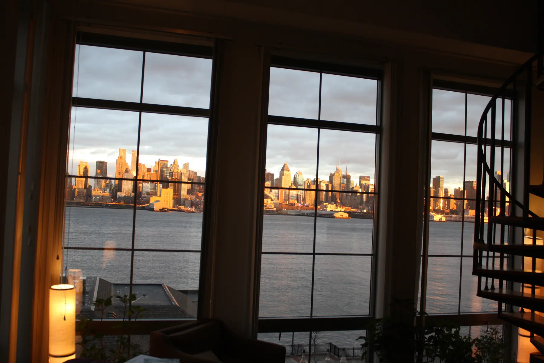 Manhattan framed by the tall windows inside Benny Doro's home at Port Imperial