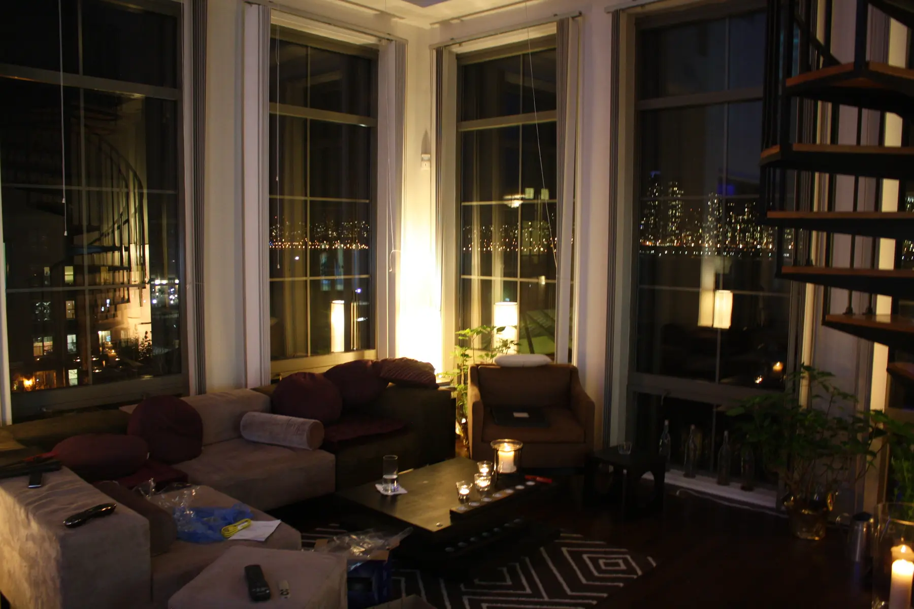 The lived-in gathering room with Manhattan sparkling beyond the windows.