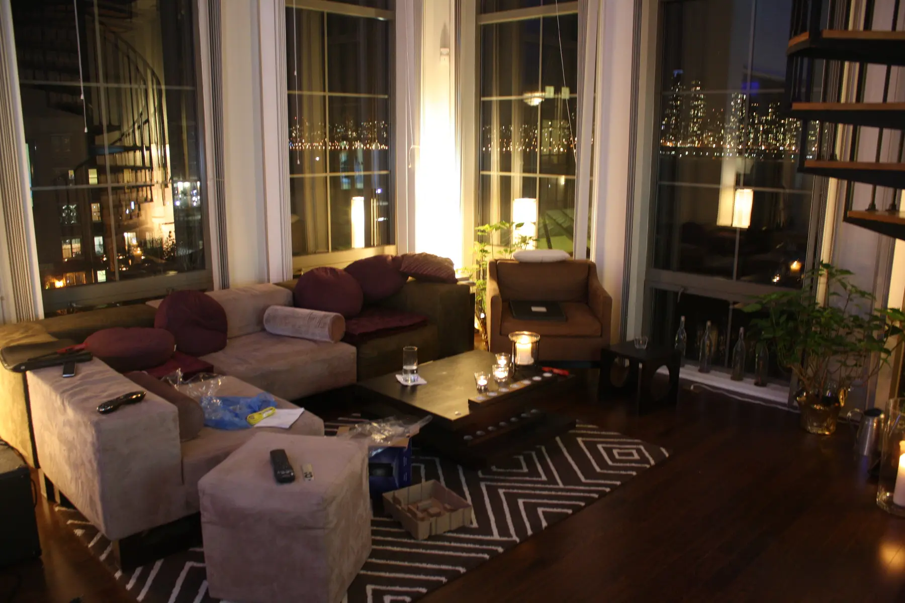 The couch, candles, plants and city lights inside 24 Ave.