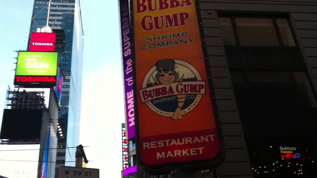 The camera tilts toward the signs and buildings of Times Square.