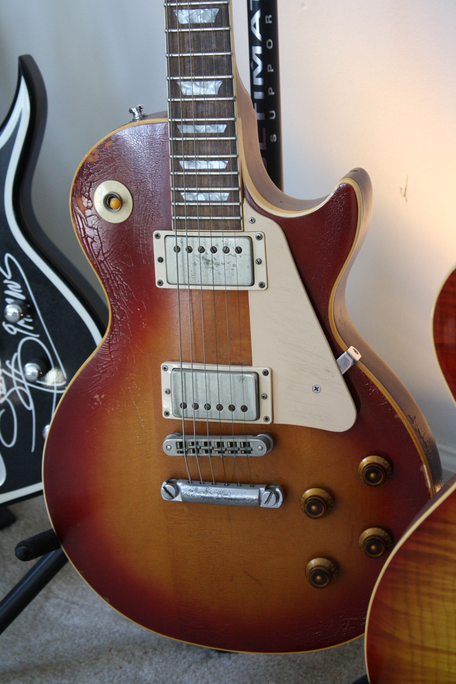 A sunburst Les Paul electric guitar photographed closely.