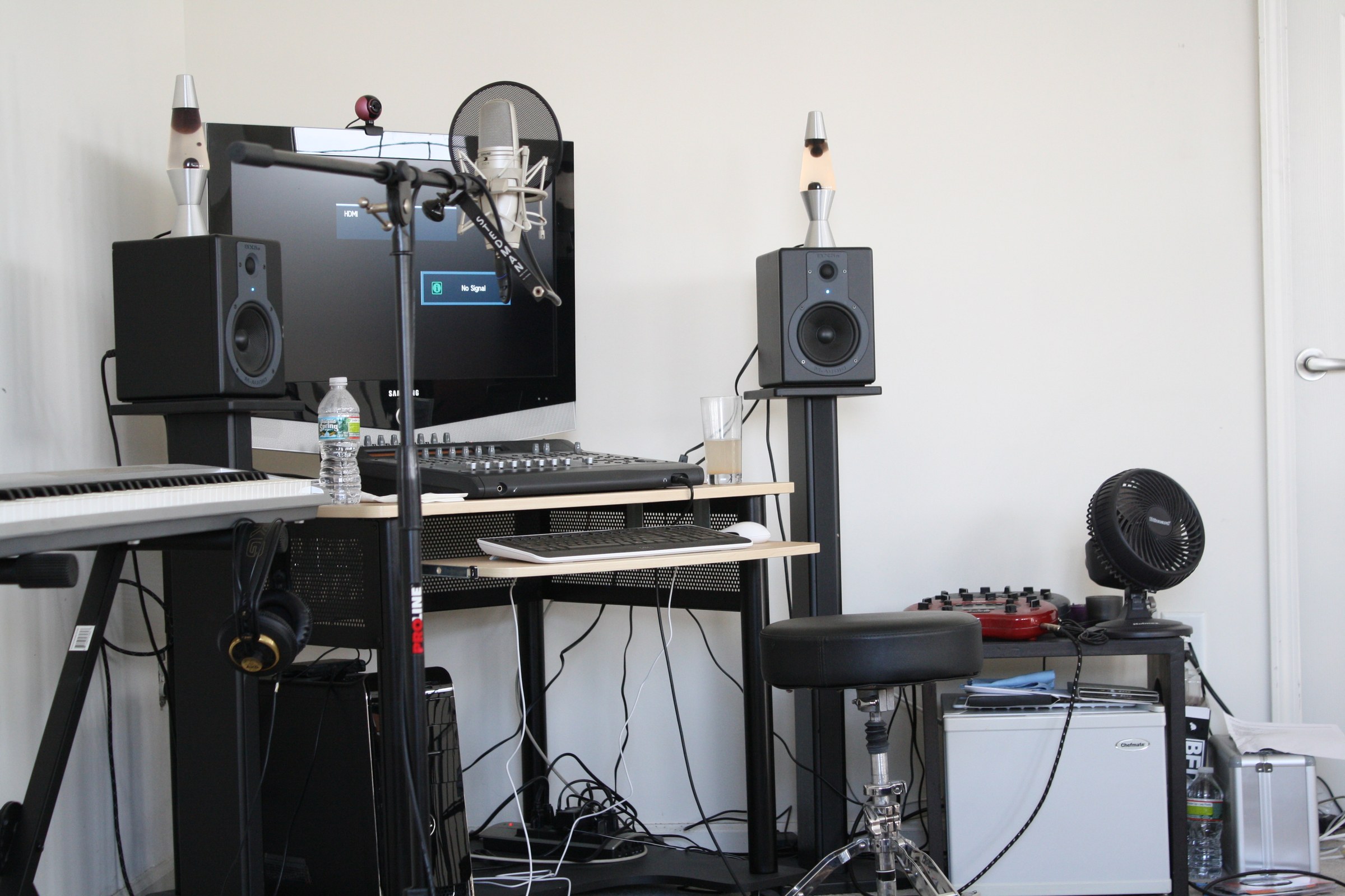 Benny Doro's studio recording desk, speakers, computer, and keyboard.