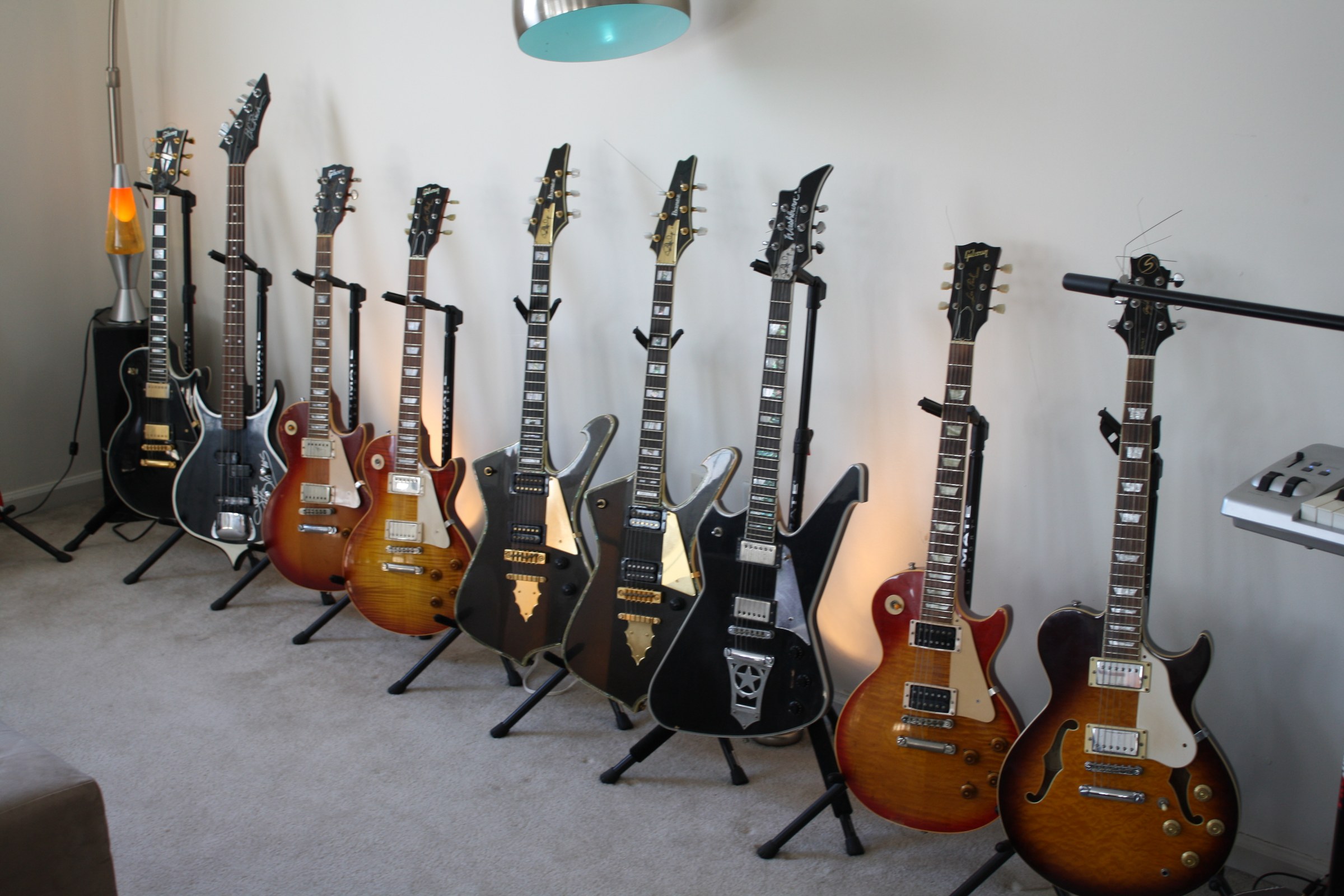 A long row of electric guitars arranged on stands inside Benny Doro's West New York studio.